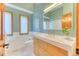 Stylish bathroom featuring a wood vanity, modern fixtures, quartz countertop, and refreshing green walls at 13830 Silverton Dr, Broomfield, CO 80020