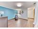 Inviting bedroom with wood laminate flooring, bright blue accent wall, and a comfortable chair with ottoman at 13830 Silverton Dr, Broomfield, CO 80020