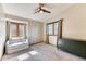 Bright bedroom with neutral walls, modern furniture, ceiling fan, and abundant natural light from two large windows at 13830 Silverton Dr, Broomfield, CO 80020