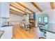 Bright dining area with wood floors, beamed ceilings, and fireplace, creating a warm gathering space at 13830 Silverton Dr, Broomfield, CO 80020