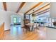 Dining room view with open layout, seamlessly connecting the kitchen and living area, with wood flooring at 13830 Silverton Dr, Broomfield, CO 80020