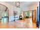 Spacious entry foyer with hardwood floors, seamlessly connecting to living spaces and a home office at 13830 Silverton Dr, Broomfield, CO 80020
