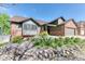 Beautiful home exterior featuring brick accents, mature landscaping, and a stone retaining wall at 13830 Silverton Dr, Broomfield, CO 80020