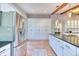 Lovely kitchen boasting stainless steel appliances, granite counters, white cabinetry, and wood floors at 13830 Silverton Dr, Broomfield, CO 80020