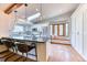 Bright kitchen features an island with seating, stainless steel appliances, and a window seat at 13830 Silverton Dr, Broomfield, CO 80020