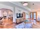 Open-concept living room with vaulted ceilings, wood floors, and seamless flow to dining and outdoor areas at 13830 Silverton Dr, Broomfield, CO 80020