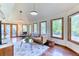 Bright living room with large windows, comfortable seating, and access to the outdoors, creating an open feel at 13830 Silverton Dr, Broomfield, CO 80020