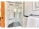 Modern tiled shower with seamless glass door, bench, and high-end fixtures, a spa-like retreat at 13830 Silverton Dr, Broomfield, CO 80020