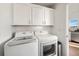 Convenient laundry room with LG washer and dryer, and upper cabinets at 10392 Tracewood Dr, Highlands Ranch, CO 80130