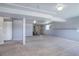 Spacious finished basement with gray carpet, fireplace, a window, and white doors at 10510 Inspiration Dr, Parker, CO 80138