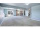 Large carpeted basement featuring sliding glass door, bar, and staircase at 10510 Inspiration Dr, Parker, CO 80138