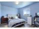 Light blue bedroom featuring wood-look floors, a window with a view, mini fridge, and closet at 10510 Inspiration Dr, Parker, CO 80138