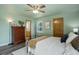 Comfortable bedroom featuring a ceiling fan and neutral decor with an ensuite bathroom at 10510 Inspiration Dr, Parker, CO 80138