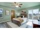 Well-lit main bedroom featuring a ceiling fan, private access to a deck, and neutral decor at 10510 Inspiration Dr, Parker, CO 80138