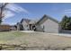 Exterior view of home featuring a backyard and sliding glass door at 10510 Inspiration Dr, Parker, CO 80138