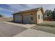 Detached garage with multiple bays, an entrance door, and ample parking space at 10510 Inspiration Dr, Parker, CO 80138