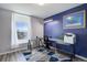 Home office space with a large window, light and dark blue walls, and gray wood-look floors at 10510 Inspiration Dr, Parker, CO 80138