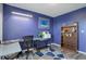 Home office space with light and dark blue walls, gray wood-look floors, and desk at 10510 Inspiration Dr, Parker, CO 80138