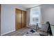Home office space with large window, wood-look floors, desk and sliding closet at 10510 Inspiration Dr, Parker, CO 80138