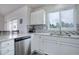 Modern kitchen with stainless steel appliances, white cabinets, and granite countertops at 10510 Inspiration Dr, Parker, CO 80138
