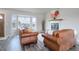 Inviting living room with a fireplace, bay windows, and comfortable seating at 10510 Inspiration Dr, Parker, CO 80138