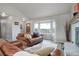 Comfortable living room with a cozy fireplace, bay windows, and stylish wood flooring at 10510 Inspiration Dr, Parker, CO 80138