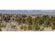 Scenic neighborhood view with trees, rolling hills, and mountain views in the distance at 10510 Inspiration Dr, Parker, CO 80138