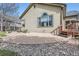 Backyard patio with beige siding, green trim, and a rock garden at 1978 Granger Cir, Castle Rock, CO 80109