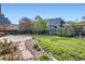 Beautiful backyard with lush green grass, landscaped garden, and stone path at 1978 Granger Cir, Castle Rock, CO 80109