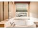 Bright bathroom with tub, shower, and window view at 1978 Granger Cir, Castle Rock, CO 80109