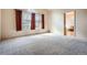 Spacious bedroom with vaulted ceiling, window, plush carpet, and access to bathroom at 1978 Granger Cir, Castle Rock, CO 80109
