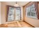 Bright dining room featuring hardwood floors, natural light, and charming window treatments at 1978 Granger Cir, Castle Rock, CO 80109