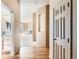 Bright hallway featuring hardwood floors, leading to a living room with a fireplace at 1978 Granger Cir, Castle Rock, CO 80109