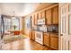 Bright kitchen with wooden cabinetry, a breakfast nook, and hardwood floors at 1978 Granger Cir, Castle Rock, CO 80109