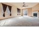 Spacious living room with neutral carpet, fireplace, and sliding glass doors at 1978 Granger Cir, Castle Rock, CO 80109