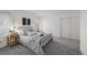 Calm bedroom with a metal frame bed, soft gray bedding, and ample closet space for storage at 1280 Sable Blvd, Aurora, CO 80011