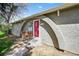 Exterior close up featuring the arched entrance, concrete steps, and a decorative red security door at 1280 Sable Blvd, Aurora, CO 80011