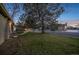 Home exterior showing a spacious front lawn and a street view with other houses in the background at 1280 Sable Blvd, Aurora, CO 80011