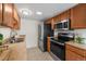 Efficient kitchen with stainless steel appliances, tile backsplash, and ample counter space at 1280 Sable Blvd, Aurora, CO 80011