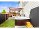 Backyard with hot tub, deck, pergola, and artificial turf at 9391 E 59Th North Pl, Denver, CO 80238
