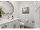 Elegant powder room featuring a decorative mirror, modern vanity, and stylish fixtures at 9391 E 59Th North Pl, Denver, CO 80238