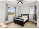Bright bedroom with a ceiling fan, two windows, and minimalist decor offering a comfortable and inviting space at 9391 E 59Th North Pl, Denver, CO 80238