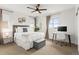 Bright bedroom features a comfortable bed, a ceiling fan, a workstation desk, and natural light at 9391 E 59Th North Pl, Denver, CO 80238