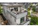 Stunning exterior view of a modern home featuring a rooftop deck with a fire pit and patio furniture at 9391 E 59Th North Pl, Denver, CO 80238