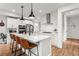 Modern kitchen features white cabinets, an island with bar seating, and stainless steel appliances at 9391 E 59Th North Pl, Denver, CO 80238
