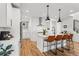 Bright kitchen with white cabinets, marble countertops, and stainless steel appliances at 9391 E 59Th North Pl, Denver, CO 80238