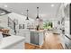 Open kitchen with large island, stainless steel appliances and hardwood flooring at 9391 E 59Th North Pl, Denver, CO 80238