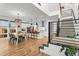 Bright, open kitchen featuring an island with bar seating, modern appliances, and a staircase at 9391 E 59Th North Pl, Denver, CO 80238
