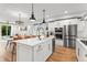 Open-concept kitchen featuring a center island, stainless steel appliances, and adjacent living area at 9391 E 59Th North Pl, Denver, CO 80238