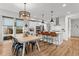 Modern kitchen with stainless steel appliances, pendant lighting, large island, and adjacent dining area at 9391 E 59Th North Pl, Denver, CO 80238